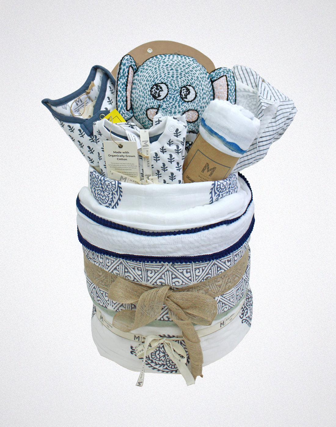 Malabar Baby luxury baby hamper with organic baby clothing, cozy blankets, and a plush stuffed animal.