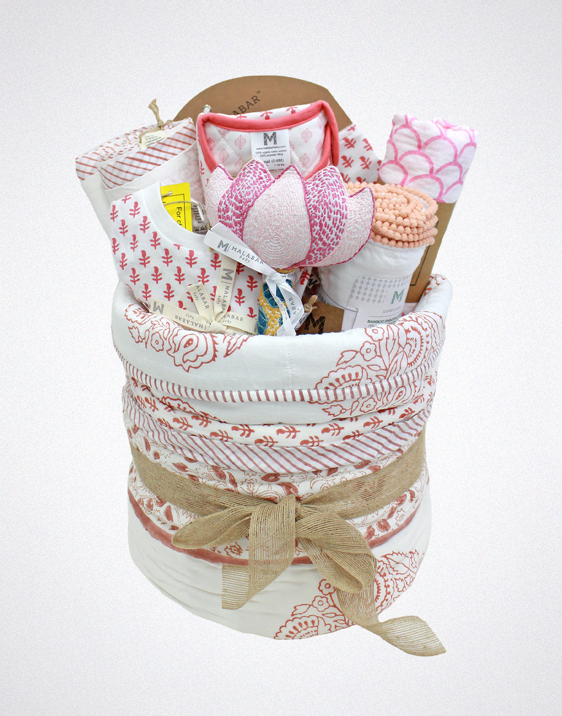 Malabar Baby luxury baby hamper with organic baby clothing, cozy blankets, and a plush stuffed animal.