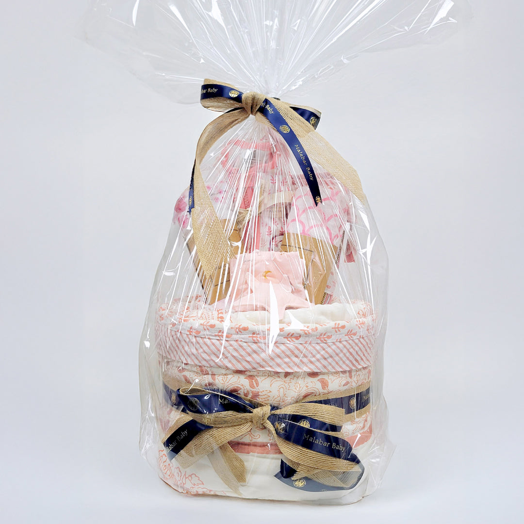 Luxury baby hamper featuring adorable clothing, plush toys, and decorative packaging from Malabar Baby, ideal for new parents.