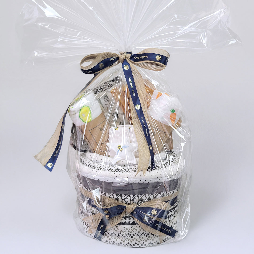 Luxury baby hamper featuring adorable clothing, plush toys, and decorative packaging from Malabar Baby, ideal for new parents.