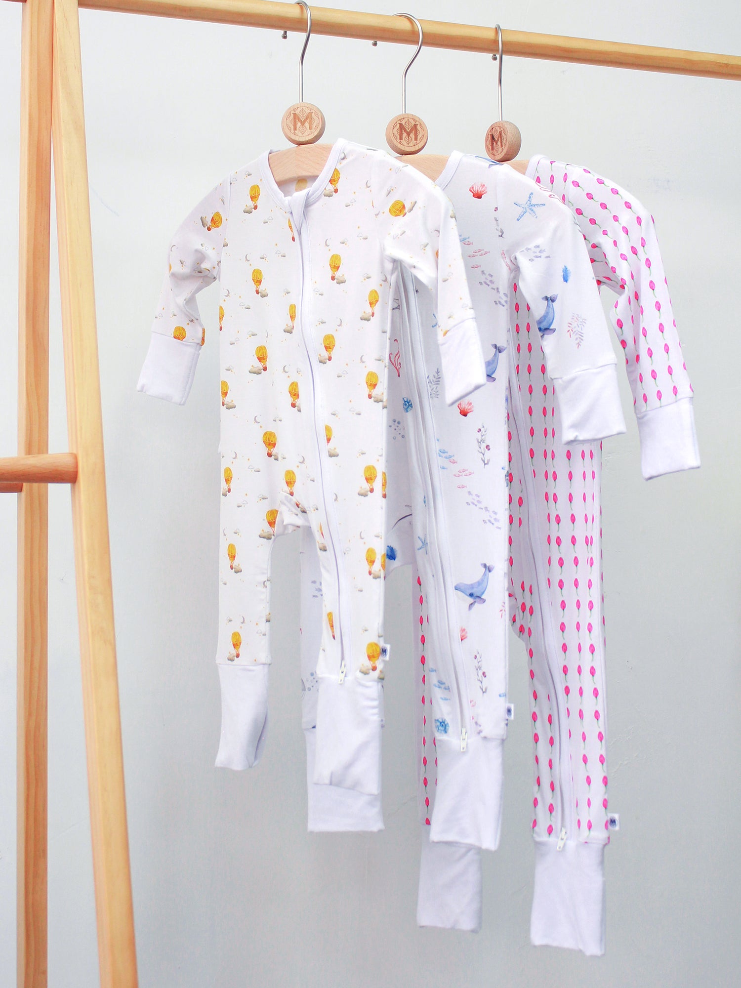 Softest baby romper by Malabar Baby, made from luxurious bamboo cotton with a two-way zipper, foldover footie and mittens, eco-friendly dyes, and OEKO-TEX® Standard 100 certification. Perfect for newborns to 12 months, offering comfort and easy dressing for your little one.
