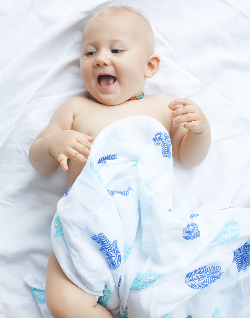 Best organic muslin swaddle blanket with adorable bee print – soft, breathable, and gentle for your baby's delicate skin. Made from premium organic cotton, this soothing swaddle features a charming watercolor hamsa print, providing natural comfort, promoting safe sleep, and perfect for calming and wrapping newborns.