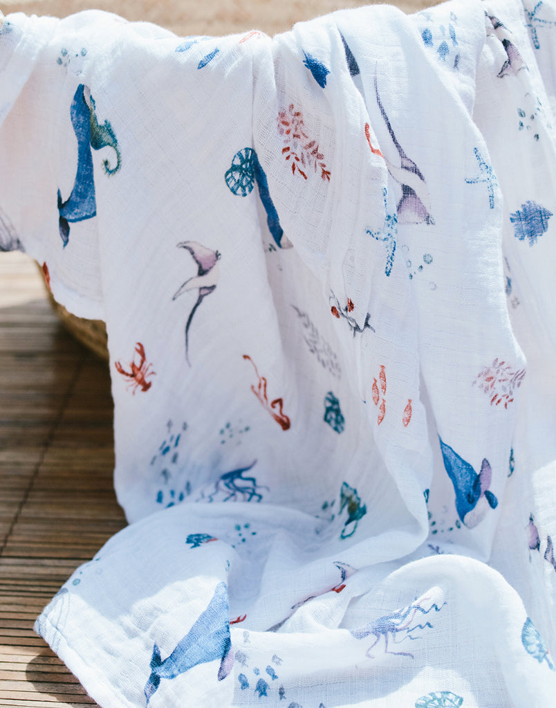 Best organic muslin swaddle blanket with adorable bee print – soft, breathable, and gentle for your baby's delicate skin. Made from premium organic cotton, this soothing swaddle features a charming watercolor under the sea print, providing natural comfort, promoting safe sleep, and perfect for calming and wrapping newborns.
