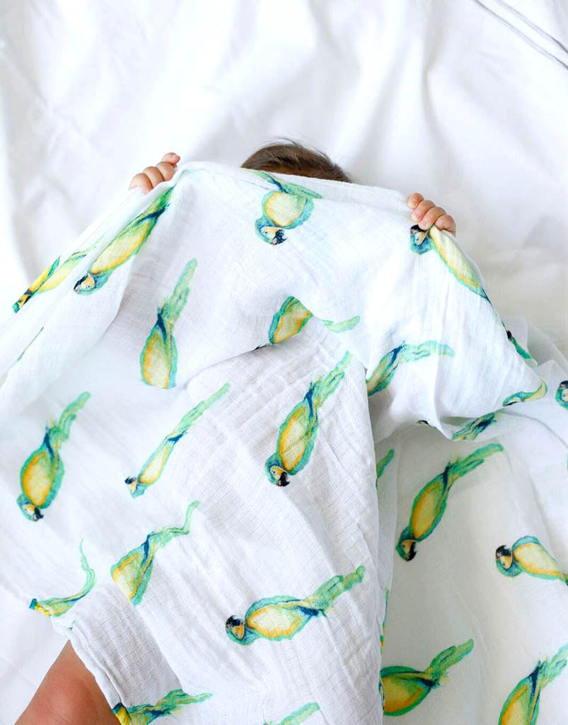 Malabar baby's 100% GOTS certified organic cotton super soft baby swaddle. Swaddle gets softer after every wash. The perfect newborn and baby shower gift. This swaddle has a beautiful green and yellow parrot design. It's stunning and gender neutral.