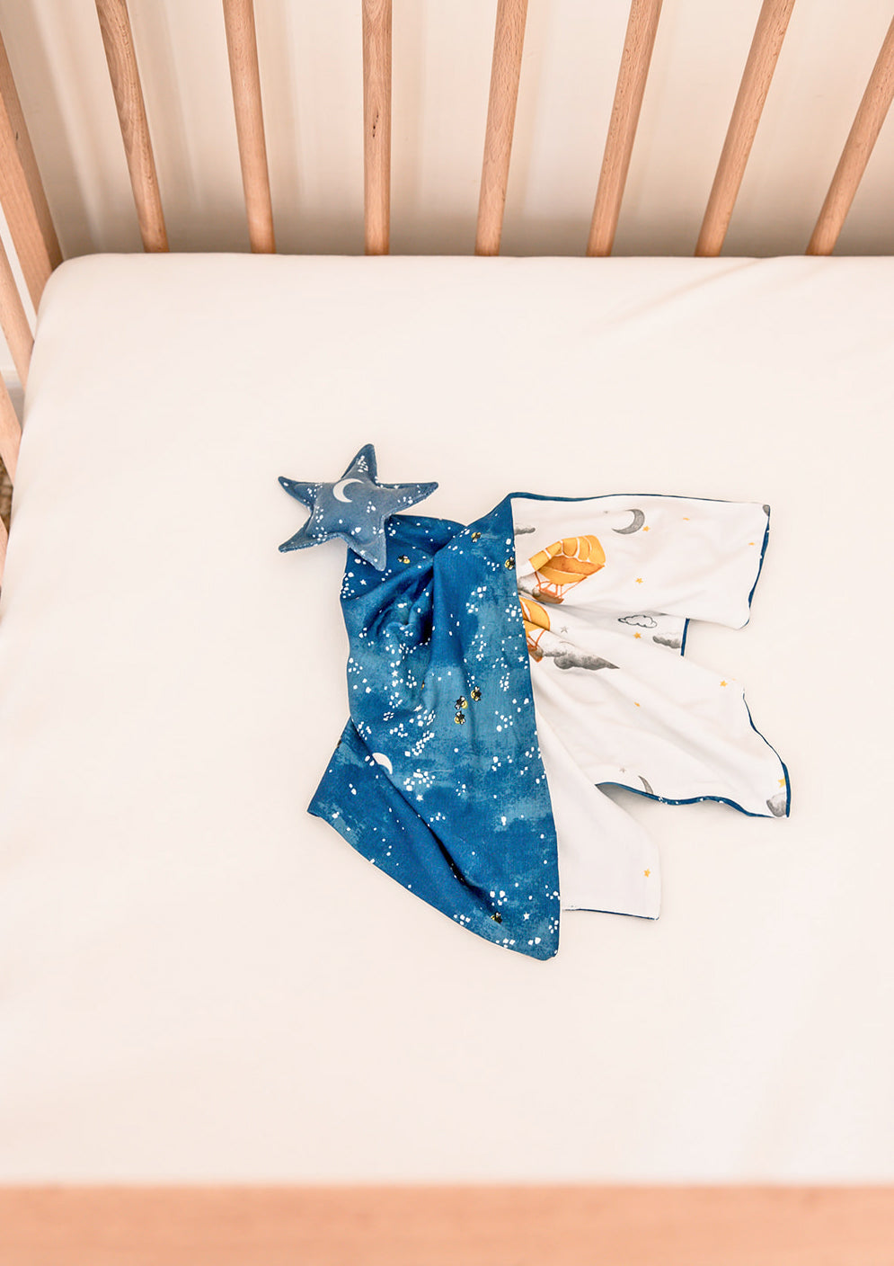 A calming baby lovey security blanket crafted with soft, high-quality fabric, featuring a detailed starry night print with twinkling stars and a crescent moon. Its soothing design helps create a peaceful bedtime environment, offering gentle reassurance and comfort for sleep routines.