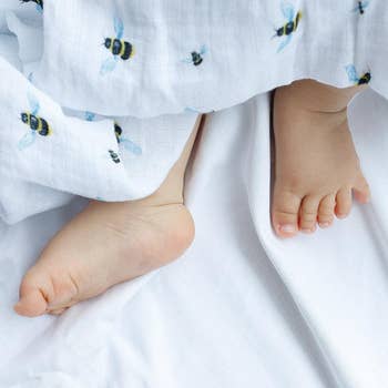 Malabar baby's 100% GOTS certified organic cotton super soft baby swaddle 2 pack. Swaddles get softer after every wash. The perfect newborn and baby shower gift. Swaddle #1 has a beautiful bee hive design and swaddle #2 has a beautiful bee design. These s