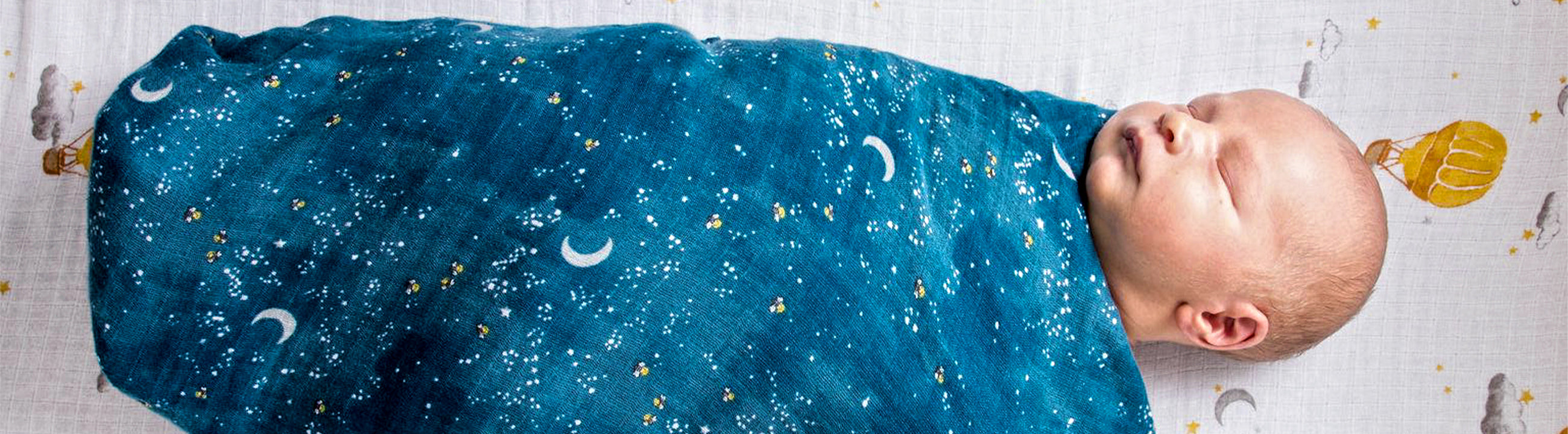Baby sleeping in the starry night swaddle