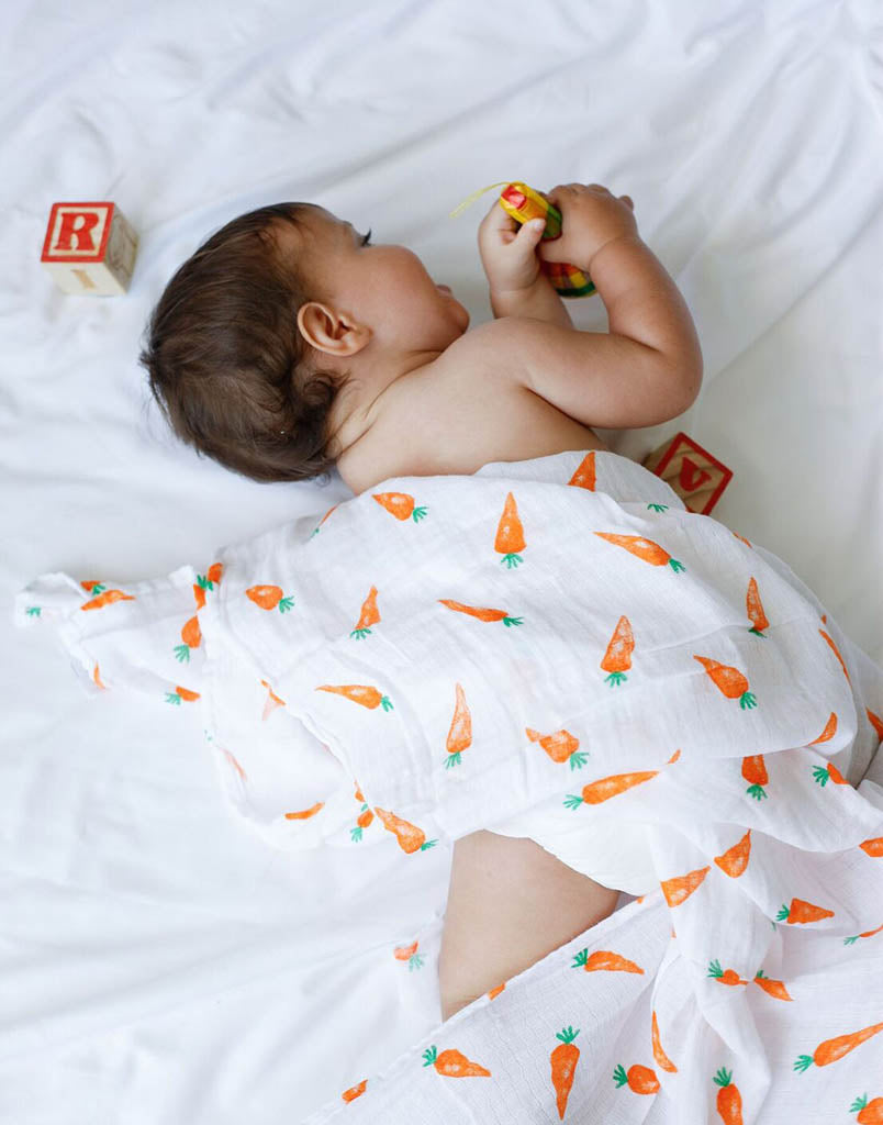 Wrapping a baby top in a muslin wrap